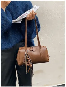 Retro PU leather bowling shoulder bag detail, vintage brown pillow bag with chic charm accents.