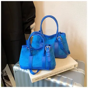 Classic blue suede patchwork tote bag with top handle and versatile shoulder strap for winter.
