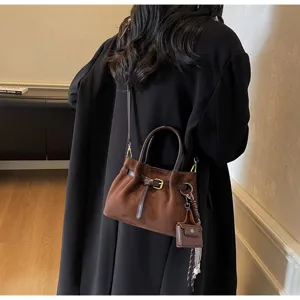 Retro brown suede handbag for women, versatile top handle shoulder crossbody bag with buckle.