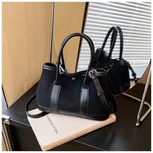 Black suede patchwork tote bag, stylish retro design with top handles and shoulder strap.