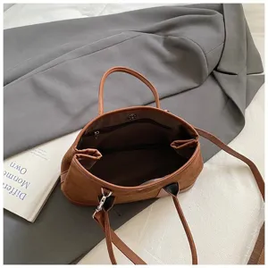 Detail shot of the brown suede patchwork handbag interior and texture, stylish and retro design.