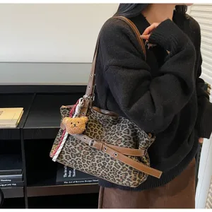 Casual leopard print shoulder bag with brown leather strap and cute bear pendant design.