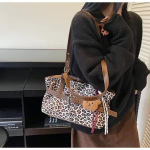 Leopard print shoulder bag with brown straps and cute bear pendant for casual daily commute.