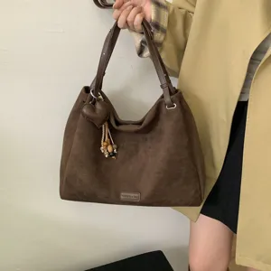 Retro brown matte shoulder bag for women, large capacity commuting handbag with cute charm.