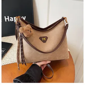 Suede shoulder bag for women, large capacity crossbody tote with cute bear pendant.