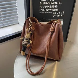 Brown leather bucket bag for women, large capacity stylish shoulder handbag with cute bunny.
