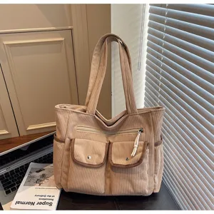 Corduroy tote bag with multiple pockets, casual shoulder bag for daily use and travel convenience.