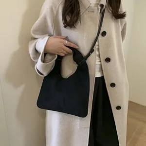Chic black shoulder bag detail, elegant knotted strap design, retro daily commute fashion accessory.