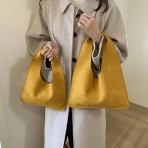 Casual suede hobo handbag, vintage minimalist style shoulder bag, retro yellow daily bag detail.