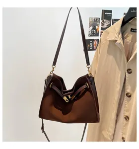Detailed view of retro brown matte tote bag with shoulder strap and metal clasp design.