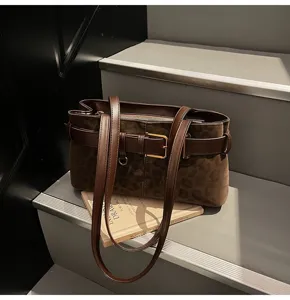 Brown suede leopard print shoulder bag with stylish belt buckle design, perfect for daily commuting.