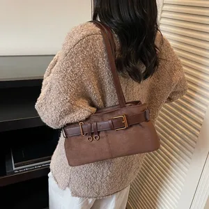 Brown suede shoulder bag for women, retro underarm handbag with chic metal belt buckle decor.