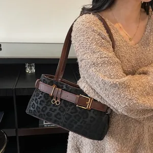 Vintage leopard print shoulder bag for women, chic suede underarm handbag with retro belt decor.
