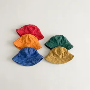 Detailed view of colorful kids solid bucket hats, soft washed cotton daily sun protection cap.