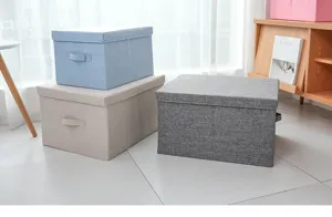 Detail view of foldable fabric storage boxes with lids, perfect for home organization.