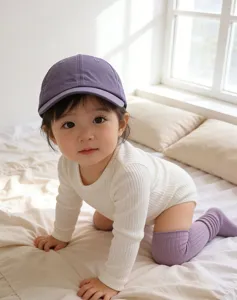 Detailed view of baby wearing a breathable quick-dry baseball cap in a warm room.
