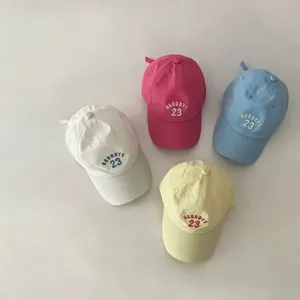 Detailed view of colorful summer children baseball caps with cute embroidery, breathable fabric.