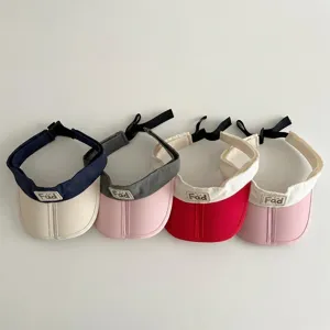 Kids empty top sun visor detail showcasing four color-blocked designs with adjustable back strap.