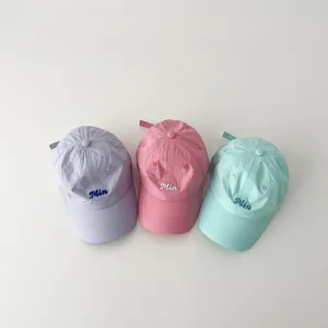 Detail view of quick-drying baby baseball caps with cute embroidered letters for summer sun.