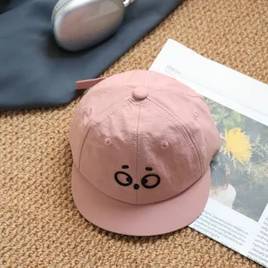 Close-up of cute big eyes kids baseball hat, pink sun protection summer baby cap detail view