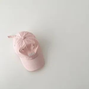 Pink kids baseball cap detail, featuring a cute embroidered letter Min and quick dry fabric.