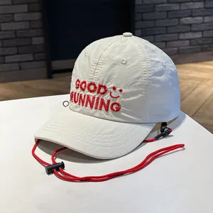 Kids quick-drying baseball cap with sun protection, red chin cord and embroidered text.