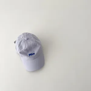 Details of the light purple kids quick-drying baseball cap featuring blue embroidered text.
