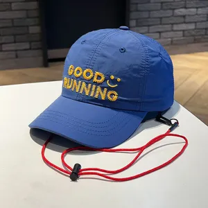 Closeup of blue kids baseball cap with yellow embroidery Good Running and red wind strap.
