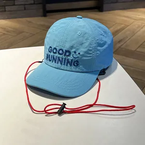 Kids quick-dry baseball cap with red windproof strap, light blue breathable sun hat detail.