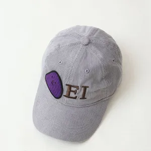 Close-up detail of grey corduroy children's baseball cap with cute purple patch and EI embroidery.