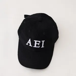Black corduroy children baseball cap detail view, featuring white embroidered letter AEI front.