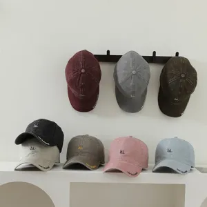 Children baseball cap detail view, featuring cute letter embroidery and washed cotton fabric.