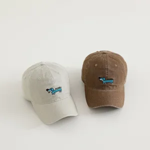 Cute children baseball cap detail showing cute puppy embroidery on washed cotton fabric.