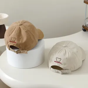Detail shot of kids baseball cap back with cute bear embroidery and adjustable metal buckle.