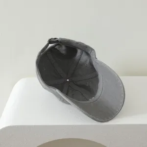 Detailed interior view of a grey kids baseball cap showing clean inner seams and back strap.