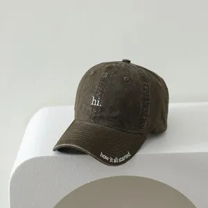 Children distressed brown baseball cap detail, white embroidered letter hi and brim text.