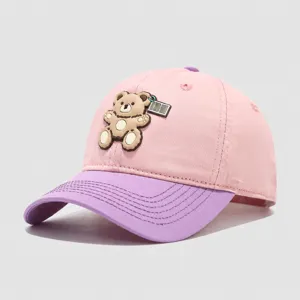 Close-up detail of the cute 3D cartoon bear patch and stitched brim on the kids baseball cap.