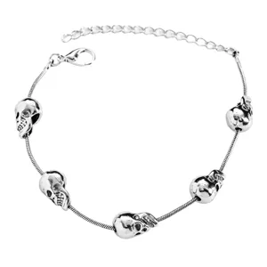 Detailopname van de retro punk gotische schedelarmband met metalen bedels en fijne schakels.
