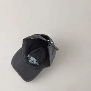 Vintage washed dark grey cotton baseball cap with inner embroidery and metal strap buckle.