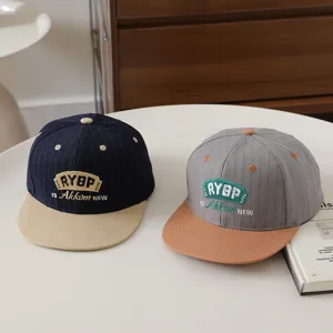 Children hip hop baseball cap with flat brim and contrast color embroidery, stylish detail view.