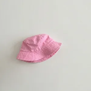 Detailed view of the pink washed cotton bucket hat, soft fabric for kids sun protection.