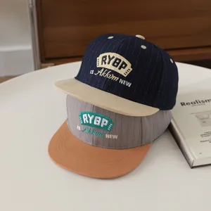 Children flat brim hip-hop baseball cap detail view, trendy embroidered autumn design.
