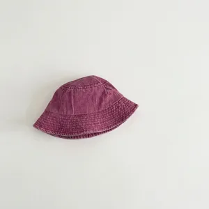 Detail view showing the soft washed cotton kids bucket hat in solid purple color design.