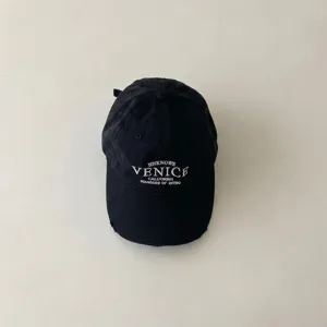 Black vintage embroidered baseball cap for kids, distressed cotton sun visor hat detail.