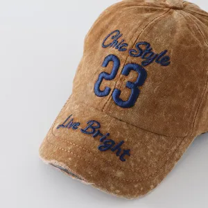 Vintage washed embroidered letter baseball cap, close-up view showing fine blue details.