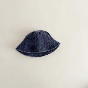 Solid color washed cotton kids bucket hat detail, soft fabric, cute sun protection daily wear.