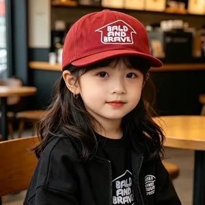 Kids red flat brim baseball hat with white embroidery, trendy casual streetwear style.