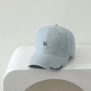 Close-up detail view of light blue children baseball cap with cute front embroidery text.