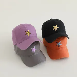 Detailed shot of cute kids baseball caps featuring starfish embroidery in multiple vibrant colors.