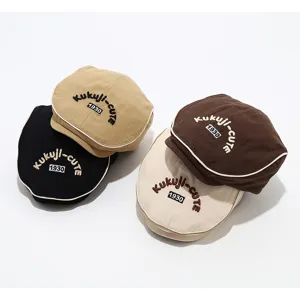 Detailed view of trendy kids beret hat with embroidery and piping, cute autumn style.